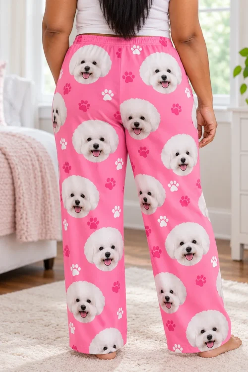 Back view of a woman standing in a bedroom in pink paws pajama pants printed with bichon frise faces