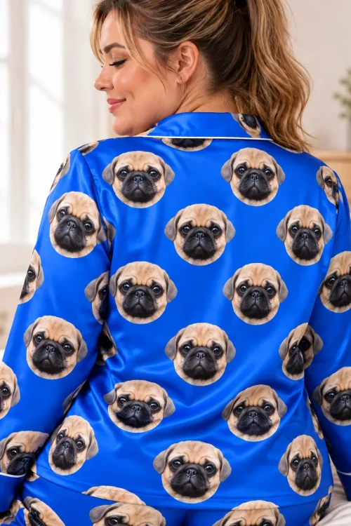 Back of a blue satin pajama shirt with rows of pug faces, worn by a woman with a ponytail