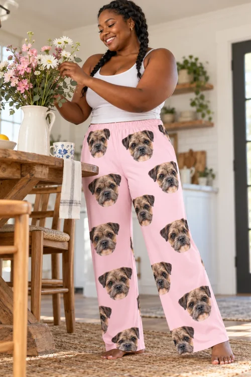 Woman in long braids arranging flowers in a farmhouse kitchen, wearing blush pink border terrier pajama pants