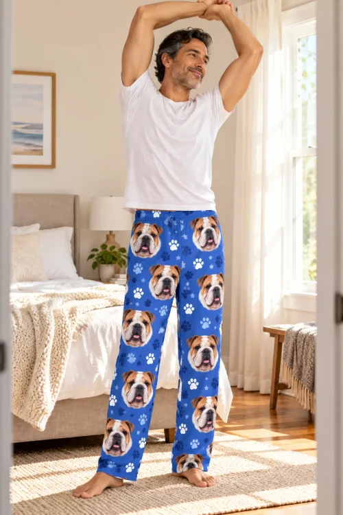 Man stretching in a bright bedroom in royal blue paws bulldog pajama pants