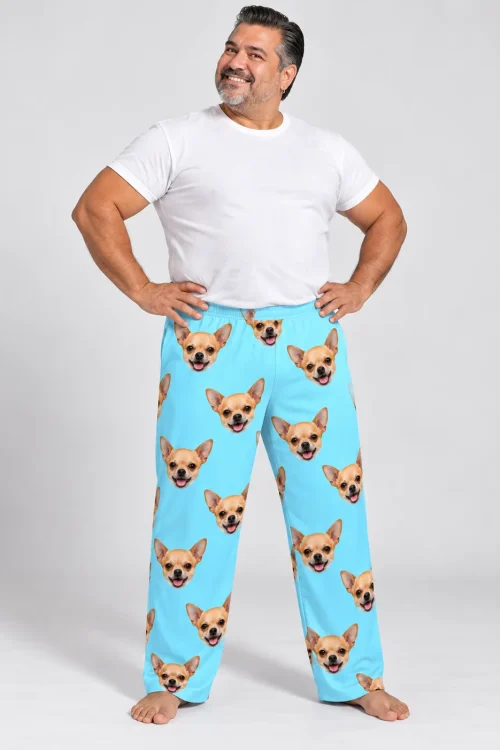 Smiling man with hands on hips in light blue chihuahua pajama pants for men, gray studio