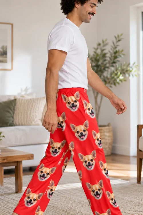 Man walking through a sunny living room in red pajama pants printed with chihuahua faces