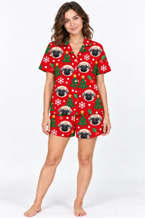 Woman in a red Christmas pajama set with pet face print: pug faces, trees and snowflakes
