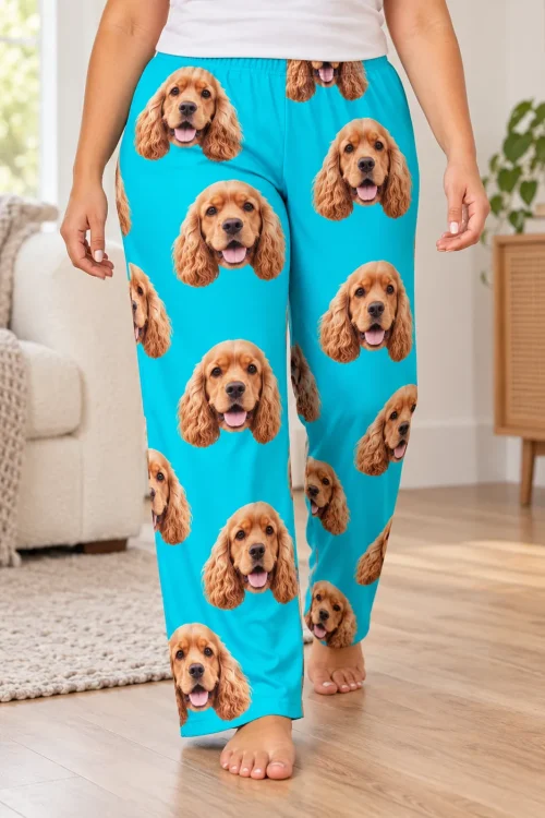 Woman walking barefoot across a wood floor in teal pajama pants printed with cocker spaniel faces