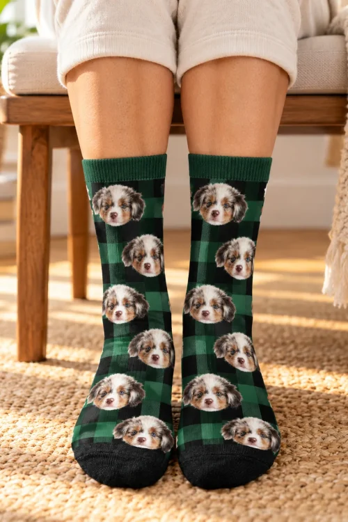 Feet standing by a wooden chair in green and black plaid socks with puppy faces
