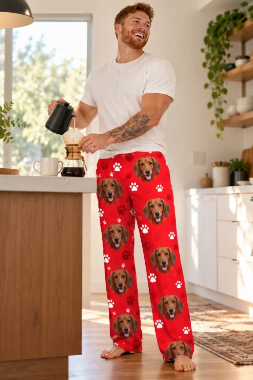 Man pouring coffee in a sunny kitchen in red paws dachshund pajama pants with doxie faces
