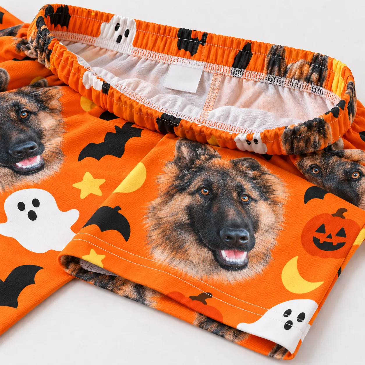 Elastic waistband and blank label inside orange Halloween pajamas with a dog face print