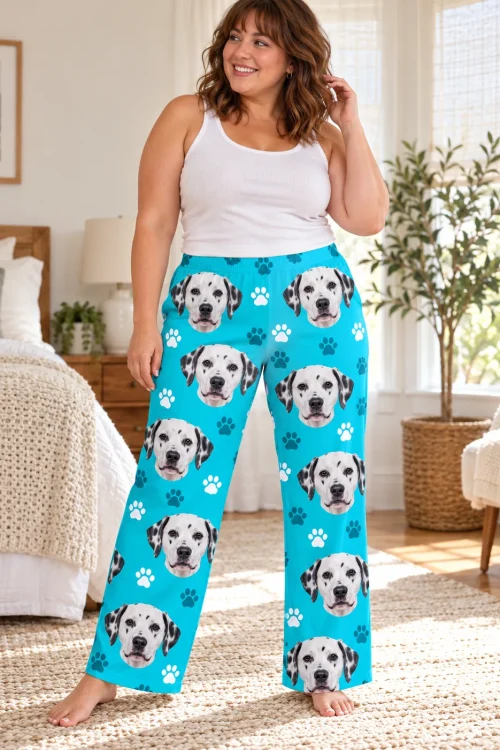 Smiling woman standing in a sunny bedroom in teal paws dalmatian pajama pants