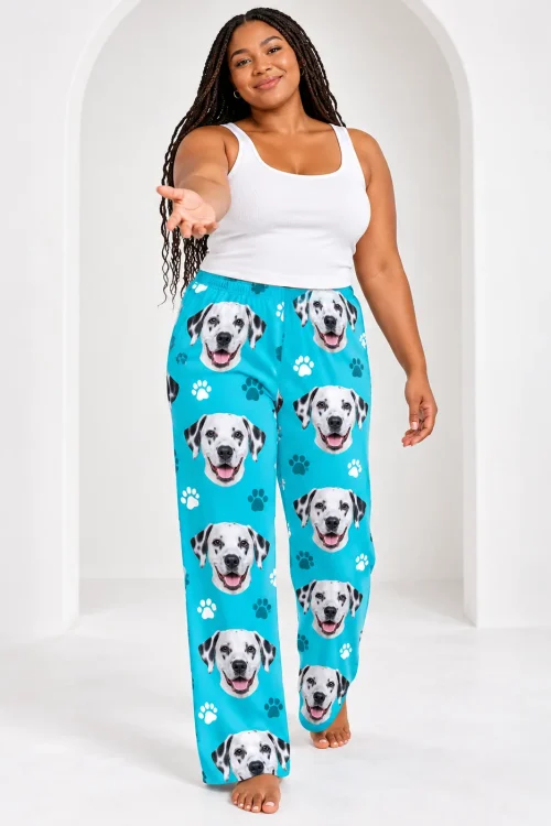 Woman with long braids walking forward in teal paws dalmatian pajama pants, white arched studio