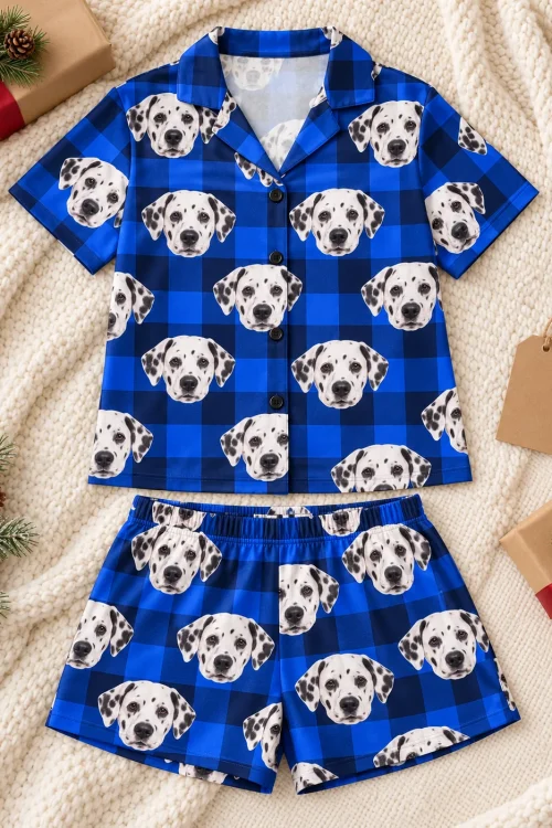 Blue plaid dalmatian pj set laid flat on a knit throw with wrapped gifts and pine sprigs