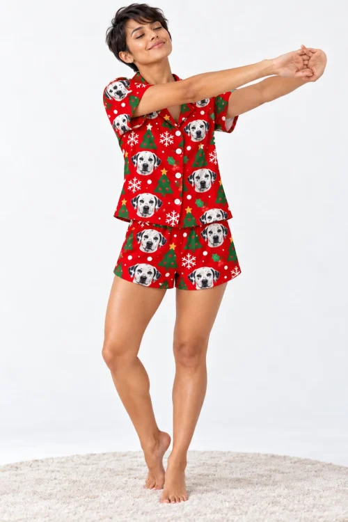 Woman stretching her arms on a round rug in a red Christmas dalmatian pj set, white studio