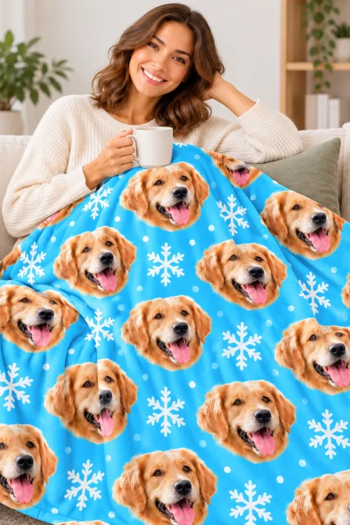Woman with a mug relaxing on the sofa under the dog face fleece blanket