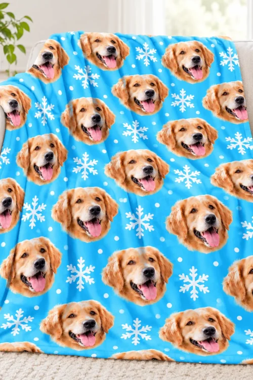 Dog face fleece blanket draped over a sofa, golden retriever snowflake print