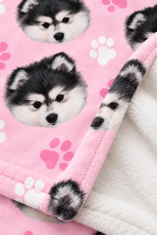 Close-up of the dog face minky blanket: husky puppy face, paw prints and plush back