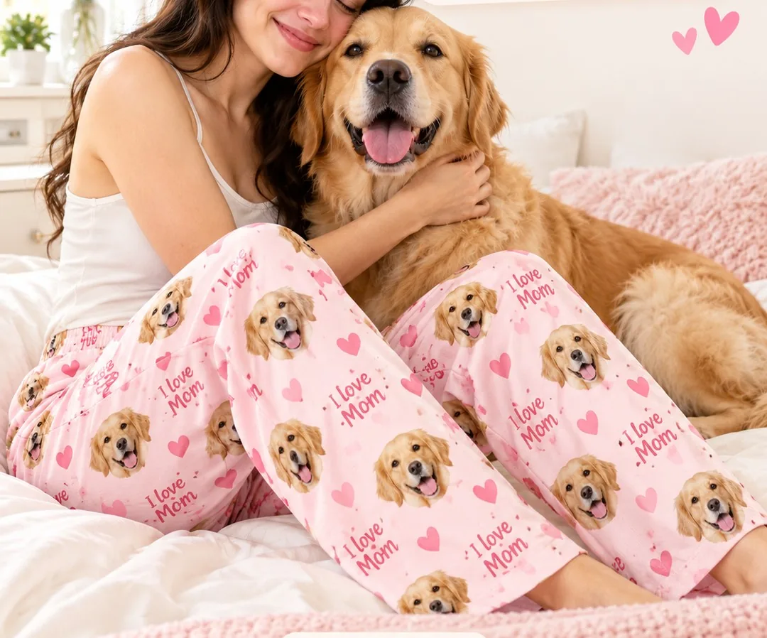 Dog mom hugging her golden retriever in pink pajama pants printed with the dog's face and the words I Love Mom