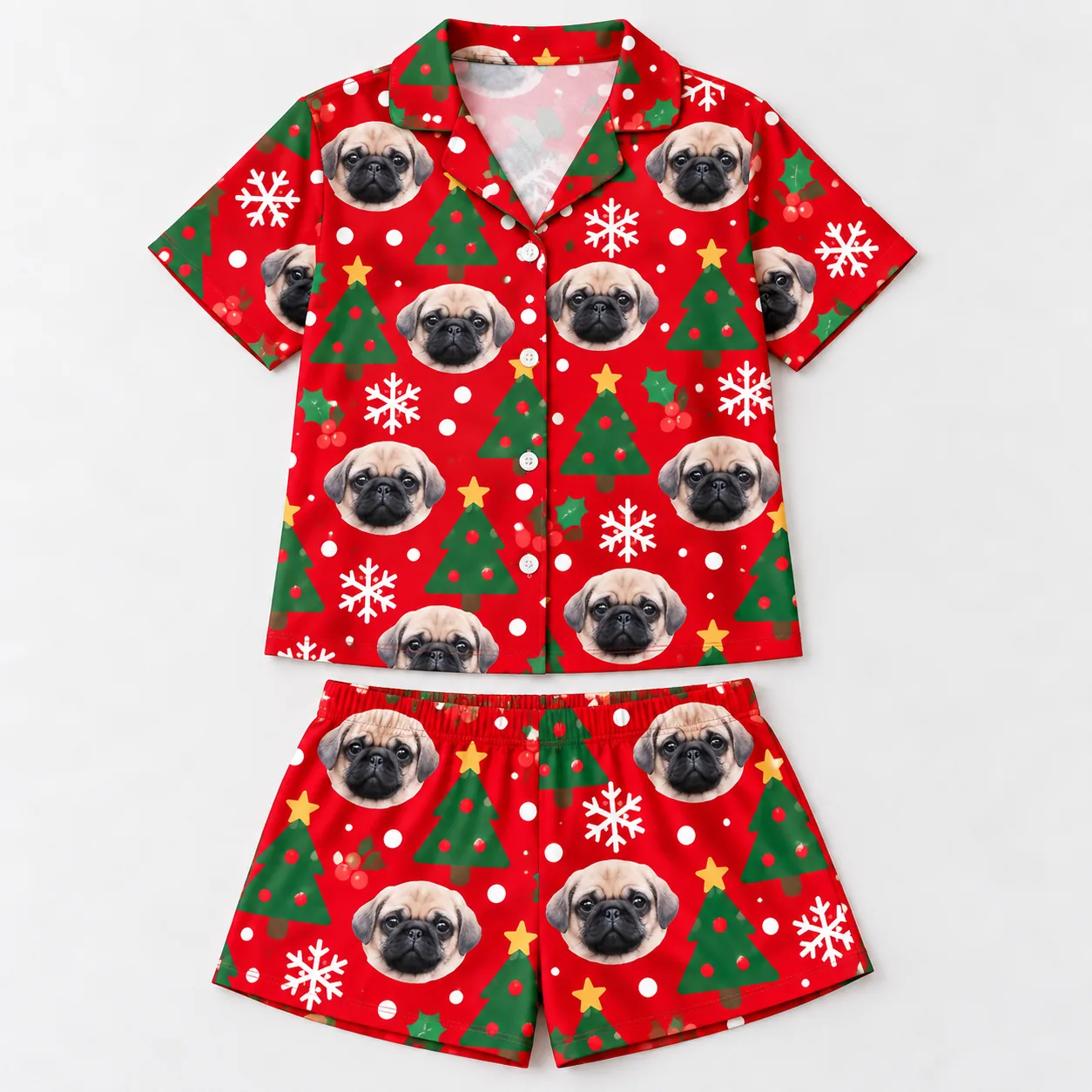 Red Christmas pajama set with pug faces, trees and snowflakes laid flat, dog print shirt above the shorts