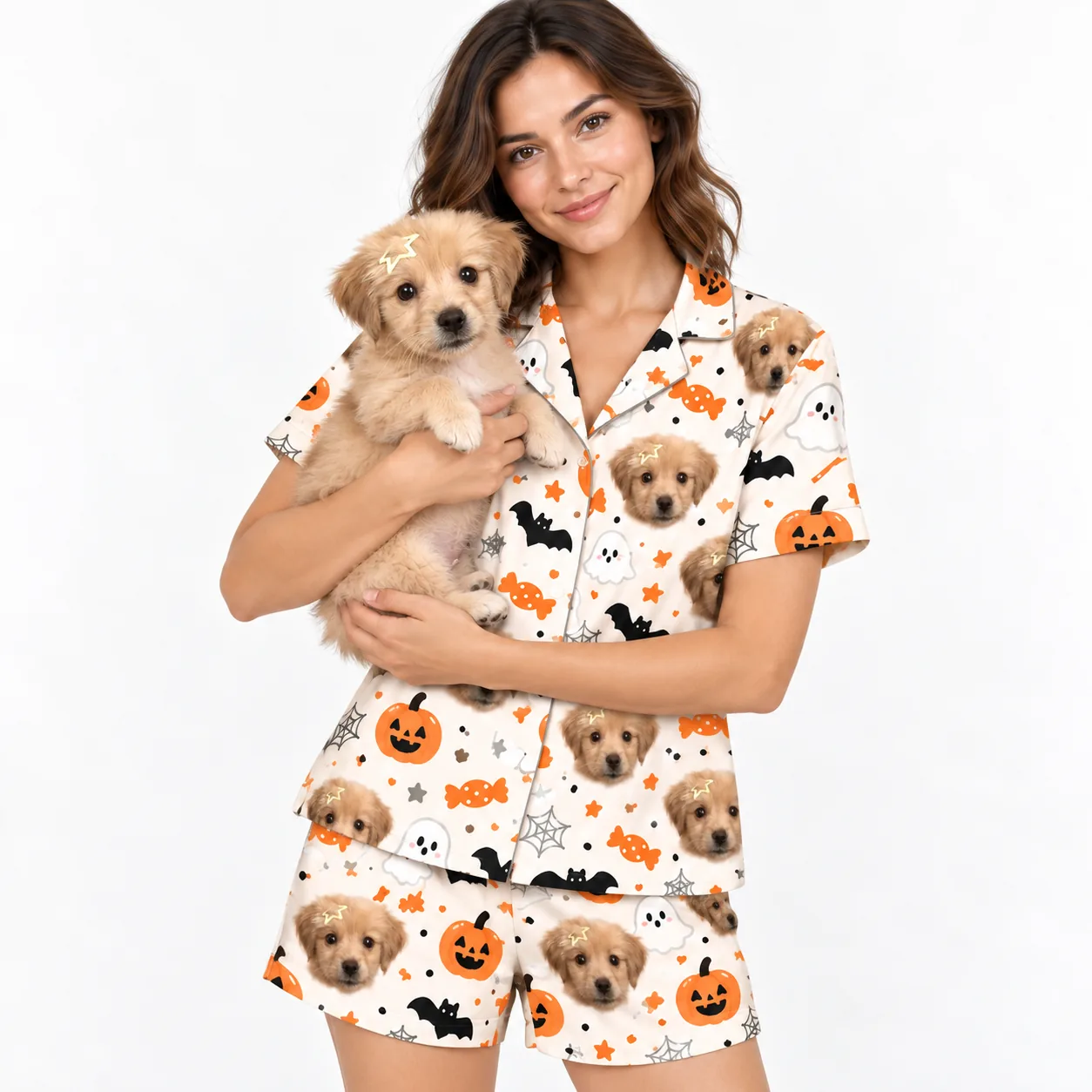 Woman holding a fluffy cream puppy, wearing Halloween pajamas printed with the puppy's face