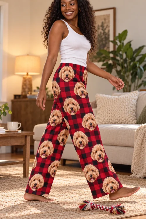 Woman walking across a living room rug in red plaid doodle pajamas for women, a rope toy at her feet