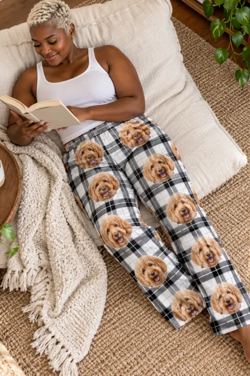 Woman reading on floor pillows in white plaid doodle pajama pants, seen from above