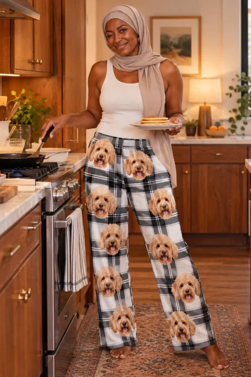 Woman in a headscarf serving pancakes in her kitchen, wearing white plaid doodle pajama pants
