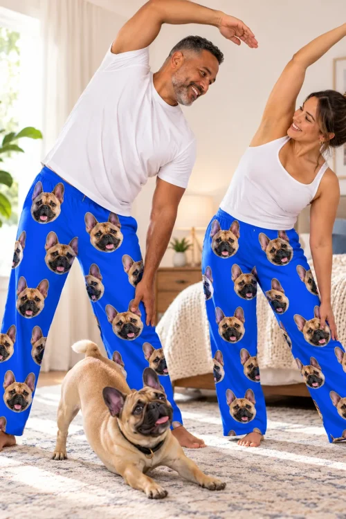 Couple stretching in a bright bedroom while their Frenchie play bows, in royal blue French bulldog pajamas