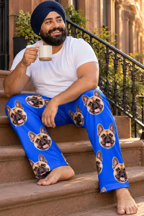 Man in a turban drinking coffee on brownstone steps in royal blue French bulldog pajamas for men