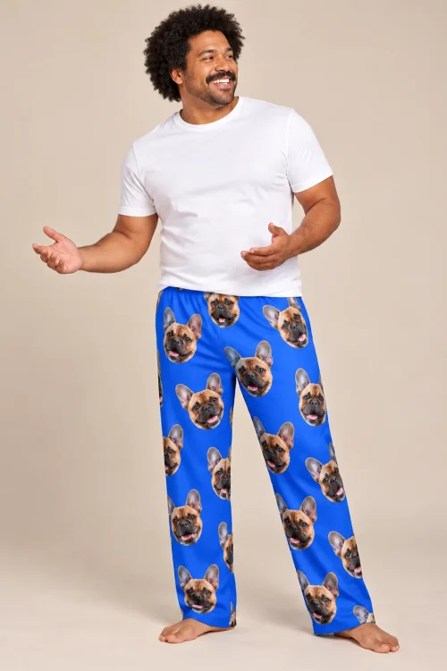 Smiling man in a white tee wearing royal blue French bulldog pajamas for men, standing in a studio
