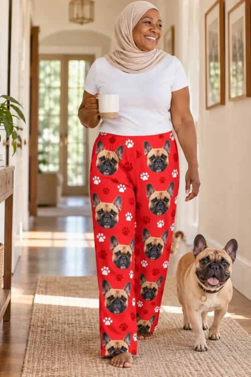 Woman in a hijab walking down a sunny hallway with her Frenchie, in red paws French bulldog pajamas