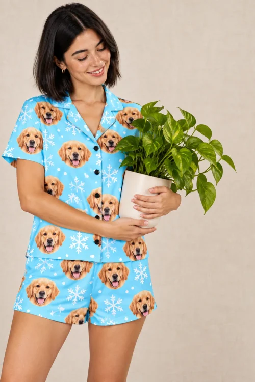 Woman hugging a potted plant in a snowflake golden retriever pajama set in a beige studio