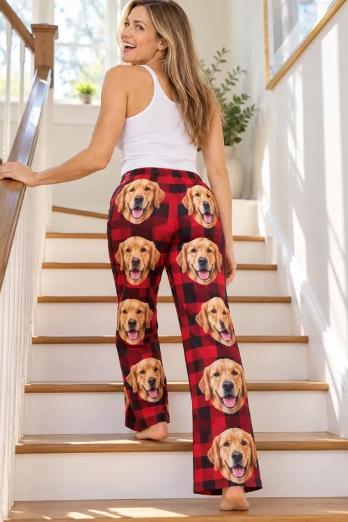 Woman climbing sunny stairs in red plaid golden retriever pajamas for women, golden faces down both legs