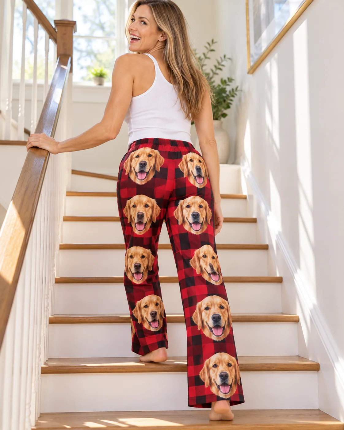 Custom Golden Retriever Pajama Pants for Women — red plaid detail | GenzOutfit Woman climbing sunny stairs in red plaid golden retriever pajamas for women, golden faces down both legs
