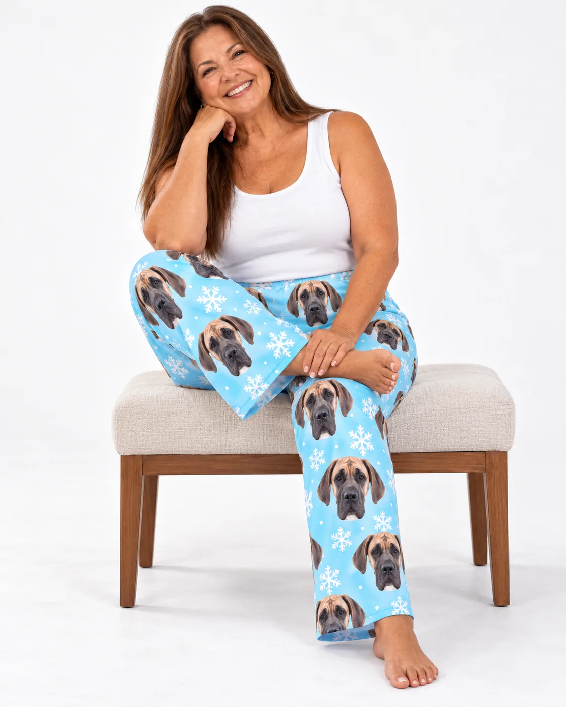 Custom Great Dane Pajama Pants for Women — snowflake studio | GenzOutfit Smiling woman perched on a bench in icy blue snowflake great dane pajama pants