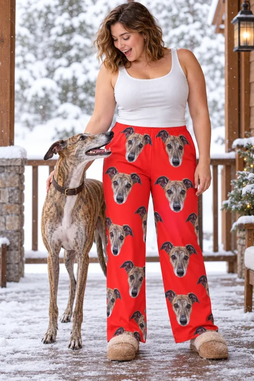Woman petting her brindle greyhound on a snowy porch beside a Christmas tree, red greyhound pajamas