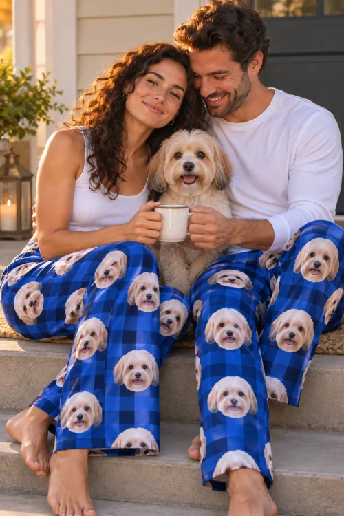 Couple sharing a mug on a porch step with their Havanese, both in blue plaid havanese pajamas