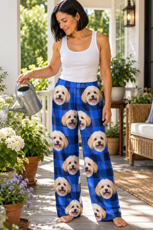 Woman watering porch flowers in blue plaid havanese pajamas printed with cream dog faces
