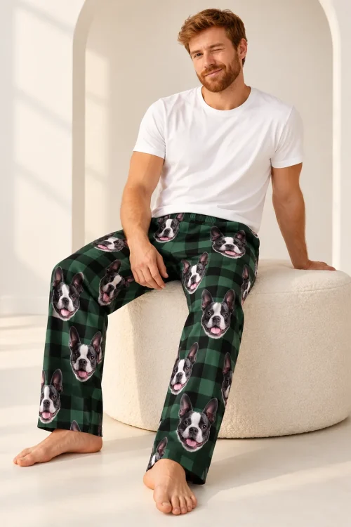 Bearded man winking on a cream pouf in green plaid Boston terrier pajama pants, arched doorway behind