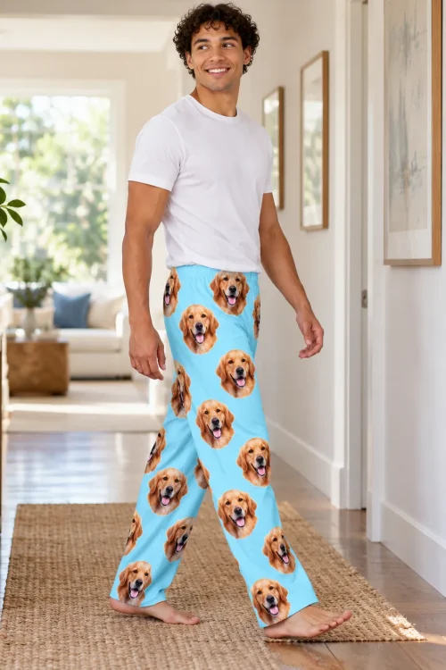 Man walking down a sunny hallway in light blue men's golden retriever pajama pants