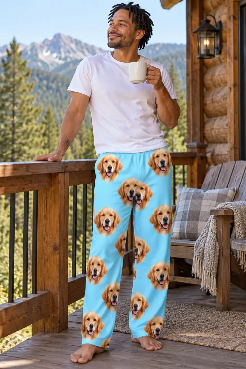 Man with coffee on a mountain cabin deck in light blue golden retriever pajama pants