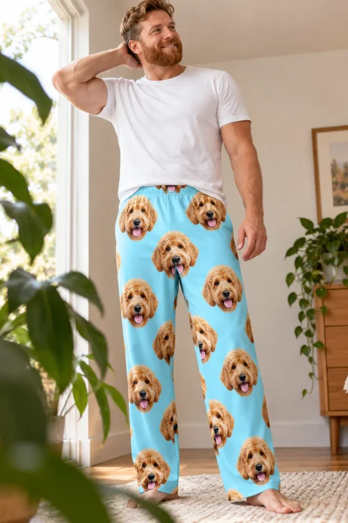 Bearded man stretching by a sunny window in light blue men's goldendoodle pajama pants