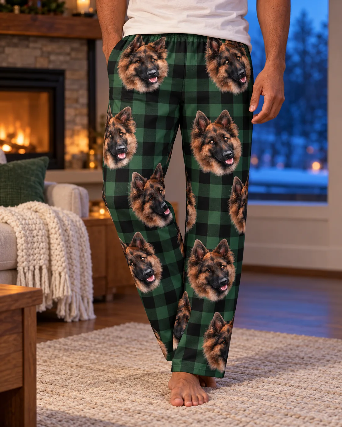 Close view of green plaid pajama pants with German Shepherd faces on a man by a glowing fireplace