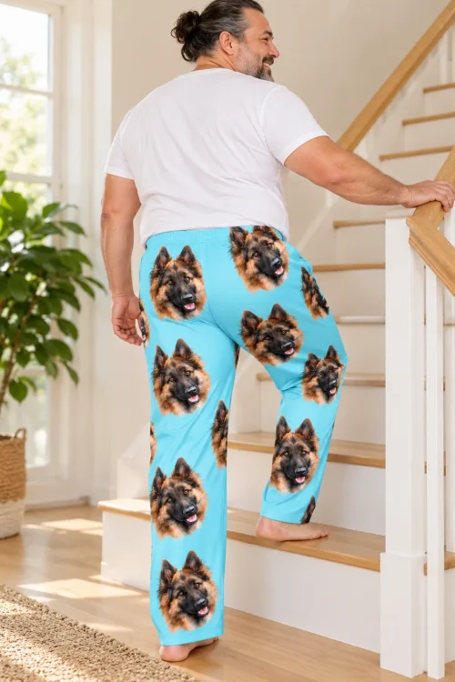 Back view of men's light blue pajama pants with German Shepherd faces as a man climbs the stairs