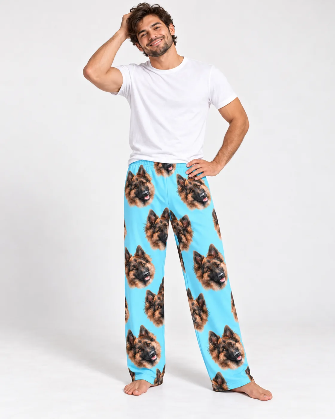 Mens pajamas: man in light blue pajama pants printed with German shepherd faces and a white tee