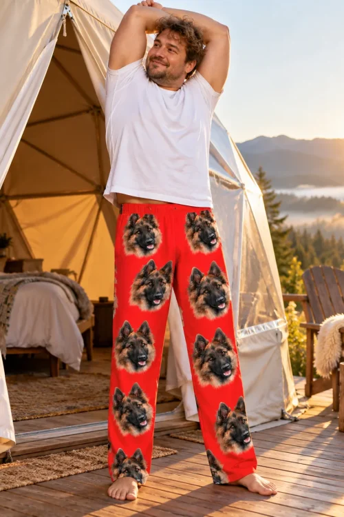 Man stretching outside a glamping tent at sunrise in red pajama pants with German Shepherd faces