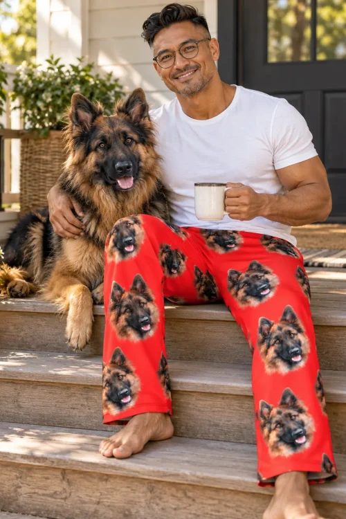 Man on porch steps with coffee and his German Shepherd, wearing red pajama pants with its face