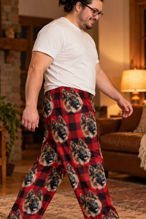 Man walking through a cabin living room in red plaid pajama pants with German Shepherd faces