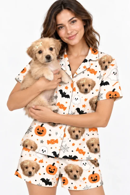 Woman holding her puppy in a Halloween pajama set printed with the puppy's face