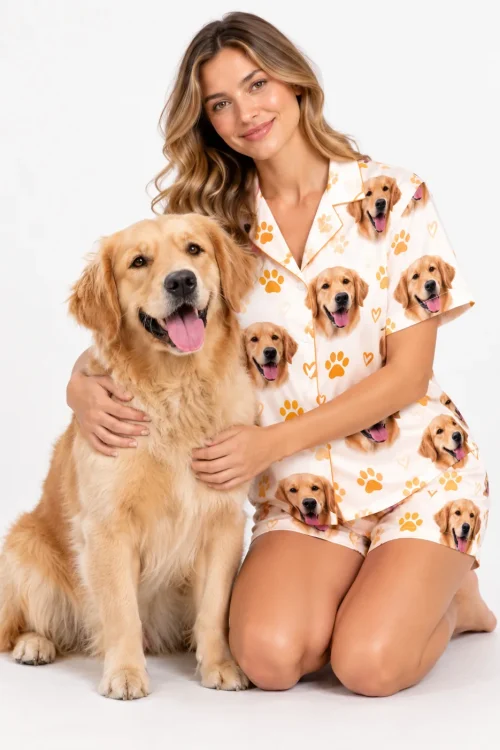 Woman kneeling with her golden retriever in a matching pet face pajama set