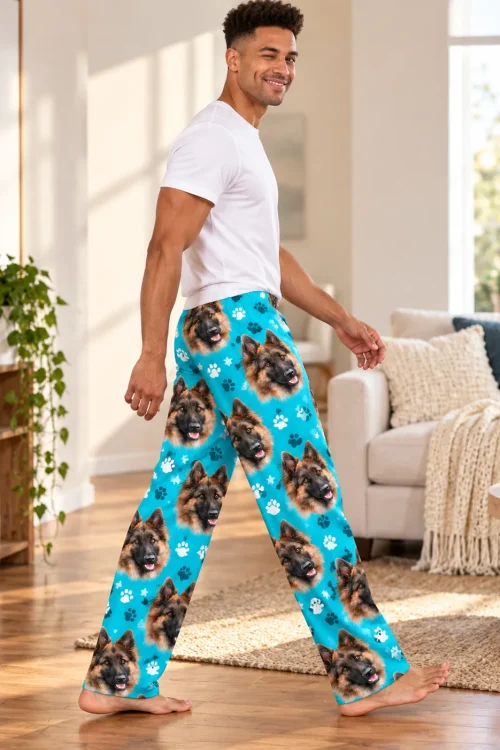 Man walks through a bright living room in teal paws pajama pants with German shepherd faces