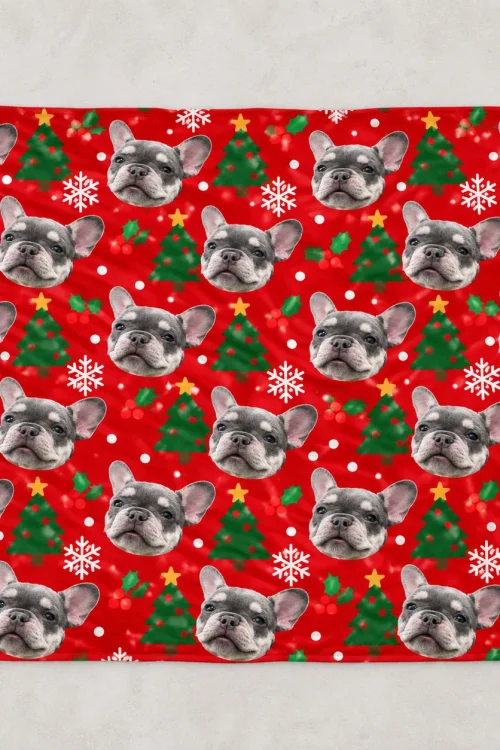 Pet face blanket laid flat: French bulldog faces on red with Christmas trees and snowflakes