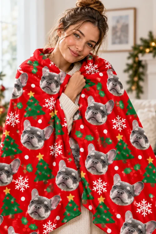 Woman wrapped in a pet face blanket next to a Christmas tree